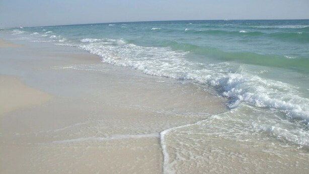 A beach with gentle waves lapping onto the shore. - 😎 Sun, Fun, Beach and Sand😎  FREE Beach Chairs!!  3 payments available Book now  (Panama City)
