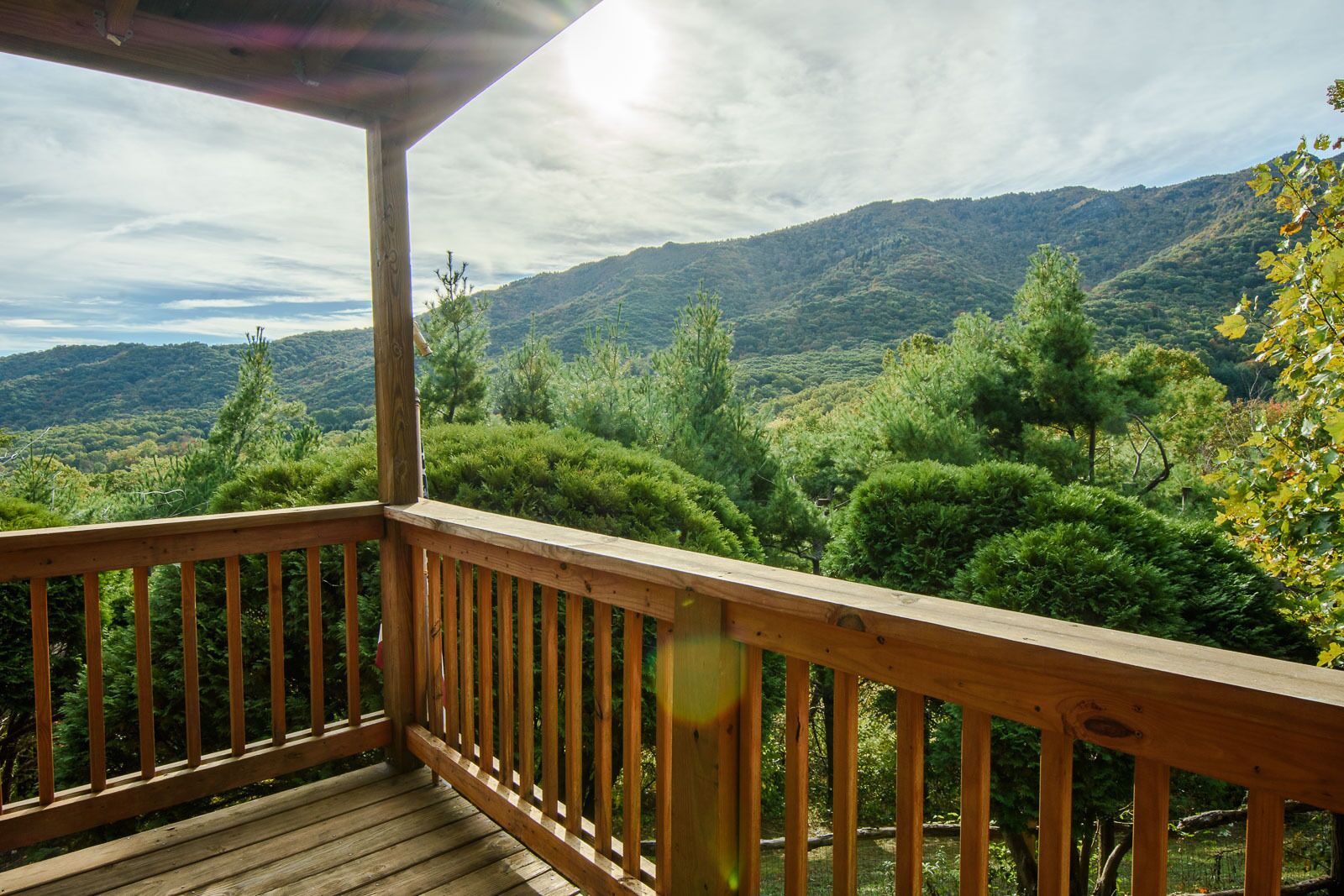 Eine Holzterrasse mit Blick auf eine gebirgige Landschaft.
