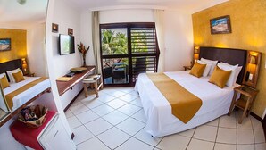A hotel room with two beds, a desk, a TV, and a balcony with a view of palm trees. - Duro Beach Hotel (Caucaia)