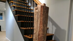 A staircase with wooden steps and black metal railings.