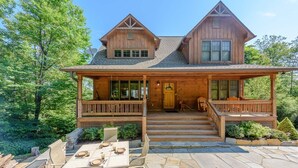 A wooden cabin with a porch, stone patio, and outdoor seating. - Perfect Mountain Getaway with Amazing Views (Banner Elk)