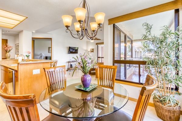Enjoy meals in this dining area with a round table and comfortable chairs, surrounded by a beautiful view.