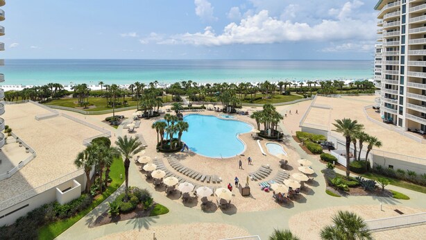 A resort with a central swimming pool, beach area, and a view of the ocean. - Calm, cool, coastal beachfront condo w/private balcony! 🐚 (Destin)