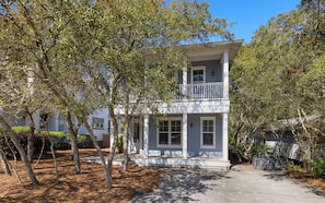 A two-story house with a balcony, surrounded by trees. - Seagrove Beach Home + Private Pool & Bikes (Santa Rosa Beach)
