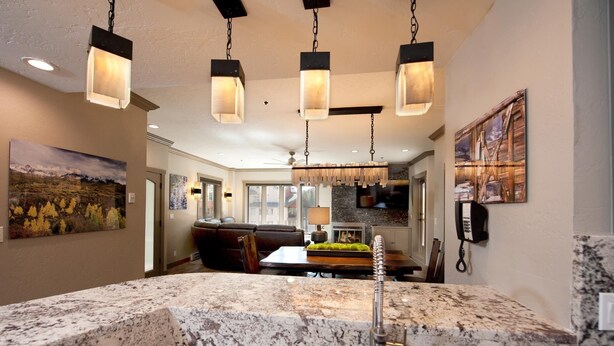 A kitchen with granite countertops, a built-in stove, and hanging pendant lights. - Remodeled Penthouse - Ski In/Out - Huge Decks/Views - Private Hot Tub/Sauna (Durango)