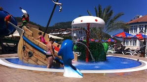 A water play area with slides and a boat-shaped structure. - Gurol Hotel & Apart (Fethiye)