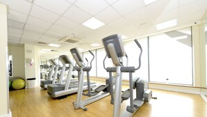 A gym with treadmills, exercise balls, and a large window. - SFA New Central Woking (Woking)