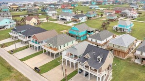 A coastal residential area with houses featuring balconies and waterfront views.
