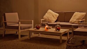 A cozy living room with a sofa, two armchairs, and a coffee table. - Biancaleuca Rooms & Suite (Castrignano del Capo)