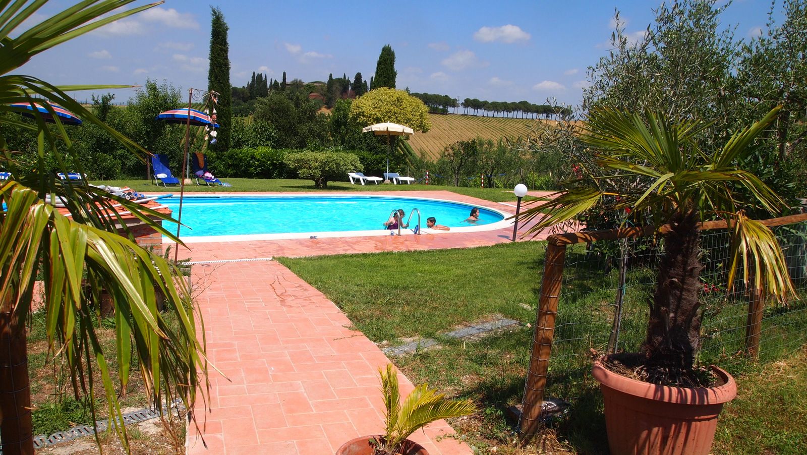 Seasonal outdoor pool, open 9:00 AM to 8:00 PM, pool umbrellas