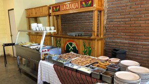 A buffet setup with various food items and a sign reading "LAGRANJA". - Navola Inn (Culiacán)