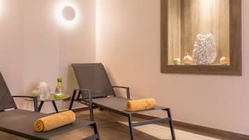 Relax in comfort with two reclining chairs, a refreshment station, and a beautiful piece of artwork.