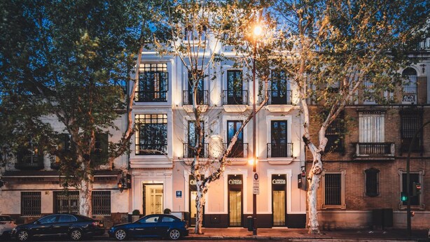 A multi-story building with a classic architectural style, featuring balconies and large windows. - Colectia Parada del Marqués. (Seville)