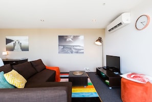 Premium Apartment, 1 Bedroom, Balcony | Living room | Flat-screen TV