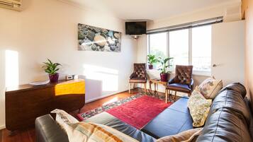 Basic Apartment, 1 Bedroom | Living room | 40-inch flat-screen TV with digital channels, TV