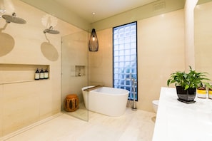 A modern bathroom with a freestanding bathtub, a large window, and a potted plant. - ELISE, 2BDR Windsor House (Windsor)