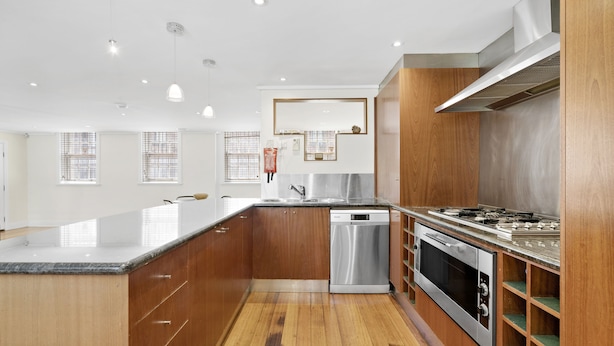 A modern kitchen with wooden cabinets, stainless steel appliances, and a large island. - HELENA, 2BDR Fitzroy House (Fitzroy)