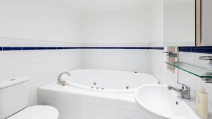 A modern bathroom with a freestanding bathtub, a toilet, and a sink. - HELENA, 2BDR Fitzroy House (Fitzroy)