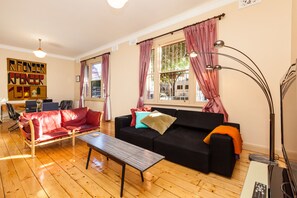 Relax in this stylish living room with a sofa, coffee table, and flat-screen TV.
