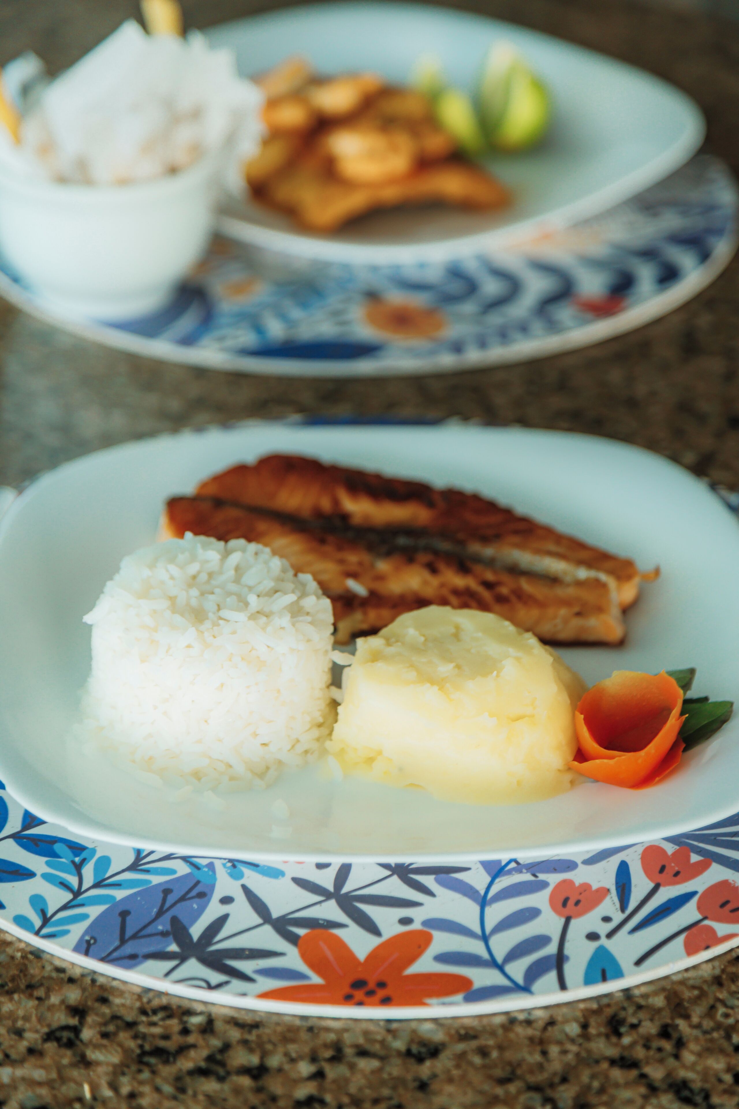 A plate with rice, mashed potatoes, and a piece of grilled meat.