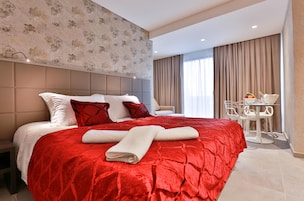 Deluxe Room, Pool View | Minibar, in-room safe, desk, iron/ironing board