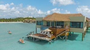 Overwater bungalows with thatched roofs, a pool, and lounge chairs. - Palafitos Overwater Bungalows, All & More Inclusive - Adults Only - All inclusive (Playa del Carmen)
