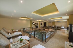 A spa area with loungers, a hot tub, and a pool.