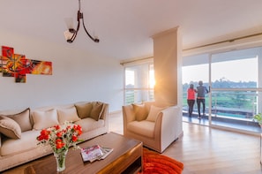 A modern living room with a sofa, coffee table, and artwork on the wall. - Lymack Suites (Nairobi)