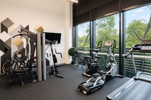 A gym with various exercise equipment, including a treadmill, stationary bikes, and weight machines. - Punthill Ivanhoe (Ivanhoe)