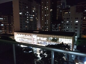 A high-rise building at night with illuminated windows.