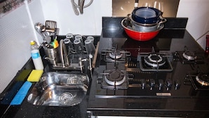 A kitchen with a gas stove, a sink, and various utensils. - Copacabana Near the Beach (Rio de Janeiro)