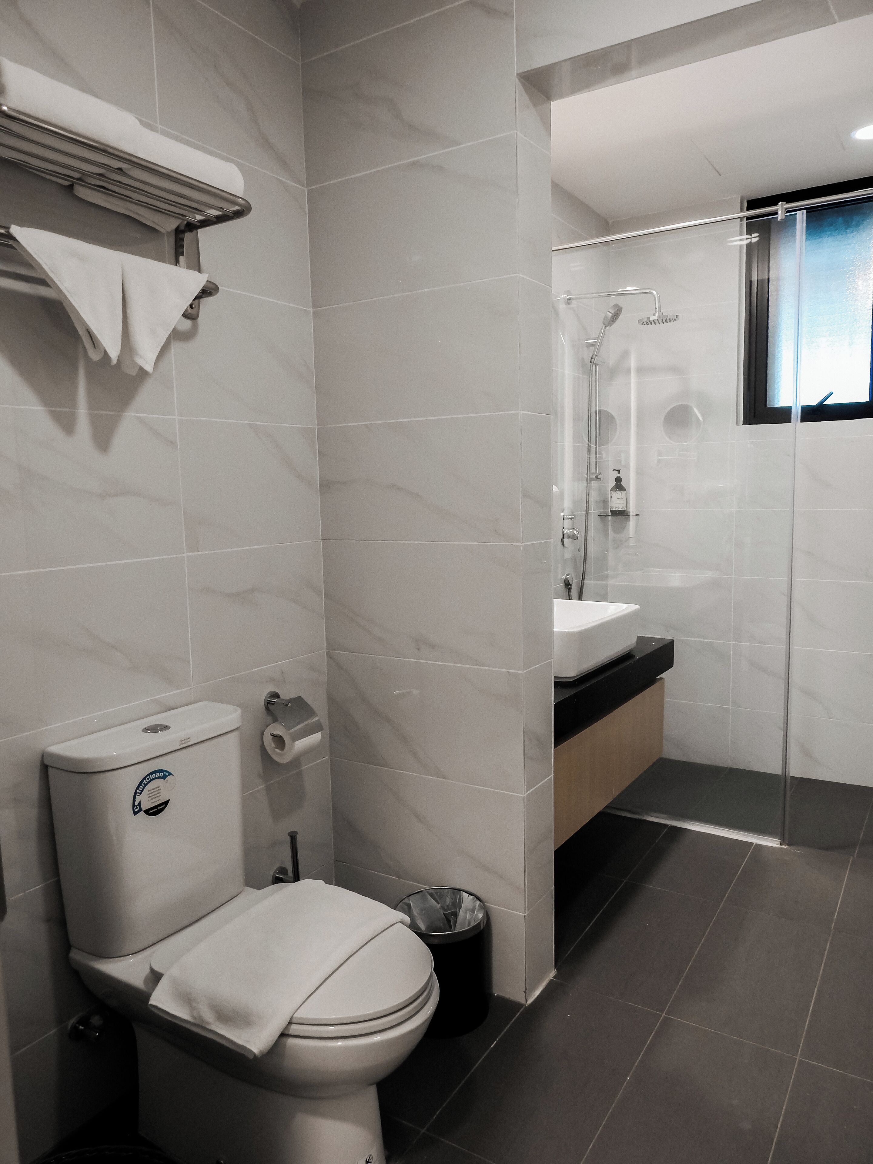 A modern bathroom with a toilet, bidet, and shower area.
