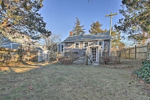 A residential property with a detached house, a garage, and a fenced yard. - Steps to Cape Cod Canal: Pet-Friendly Home (Buzzards Bay)