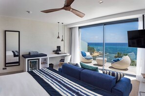 A modern hotel room with a large bed, a desk, a flat-screen TV, and a view of the ocean. - Catalonia Royal Ses Estaques (Santa Eulalia del Rio)