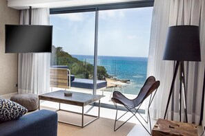 A modern hotel room with a large sliding glass door leading to a balcony with a sea view. - Catalonia Royal Ses Estaques (Santa Eulalia del Rio)
