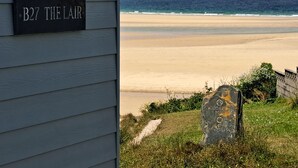 A coastal view with a sign reading "B27 THE LAIR" and a stone marker labeled "GODRE 4 MILES". - B27 The Lair, Riviere Towans (Hayle)