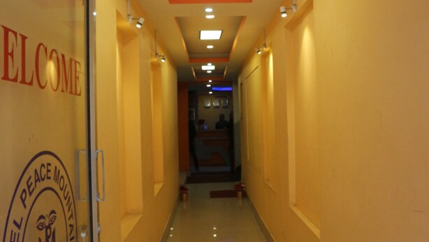A hotel corridor with a 'Welcome' sign, a 'Peace Mountain' emblem, and a 'Kathmandu' inscription. - Hotel Peace Mountain (Kathmandu)