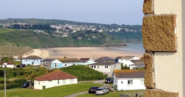 A coastal village with houses, a beach, and a stone wall. - E29 Bonnie Bank, Riviere Towans (Hayle)