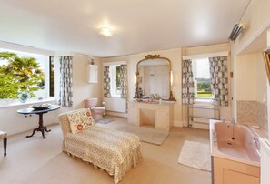 A bedroom with a bed, a vanity with a mirror, a sink, and a window with curtains. - Chapel Knap, Porlock Weir (Porlock Weir)