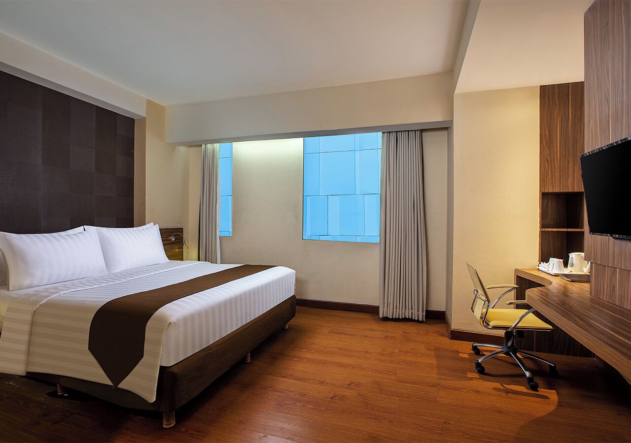 Habitación ejecutiva | Ropa de cama de alta calidad, minibar, escritorio y wifi gratis 