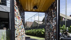 A modern structure with a wooden deck and a unique brick wall design. - M Boutique Hostel (Keroboken Kelod)