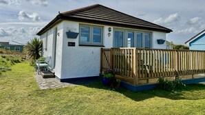 A white house with a wooden fence, a small porch, and a garden. - G03 Lanteglos (G3), Riviere Towans (Hayle)