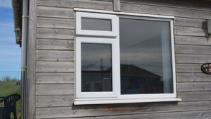 A wooden building with a large window and a sign that reads "WILM". - C23 Wilmar, Riviere Towans (Hayle)