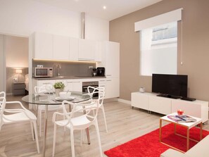A modern apartment with a kitchen, dining area, and living space.