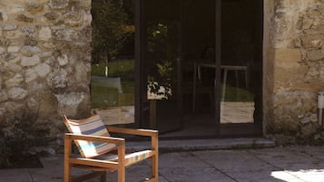 Sit on the bench and enjoy the serene view of the garden through the doorway.