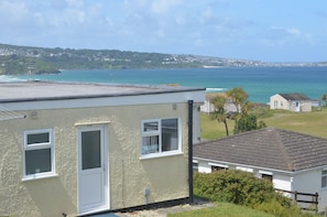 A coastal building with a flat roof, a door, and windows. - D50 Ocean Swell, Riviere Towans (Hayle)