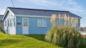 A single-story blue house with a white door, a small window, and a sign that reads 'Holiday Haunt.' - F46 Holiday Haunt, Riviere Towans (HAYLE)
