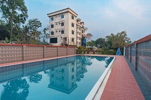 Outdoor pool, open 7:00 AM to 11:30 PM, sun loungers