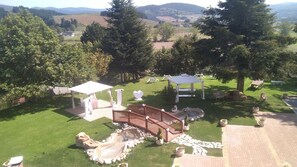 A landscaped garden with a gazebo, seating area, and a small pond. - Grandinetti Hotel (Parenti)