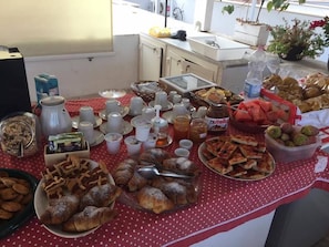A buffet table with various food items including pastries, fruits, and condiments. - B&B Cuore di Gallipoli (Gallipoli)